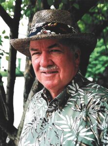 Man in Hawaiian shirt with hat on