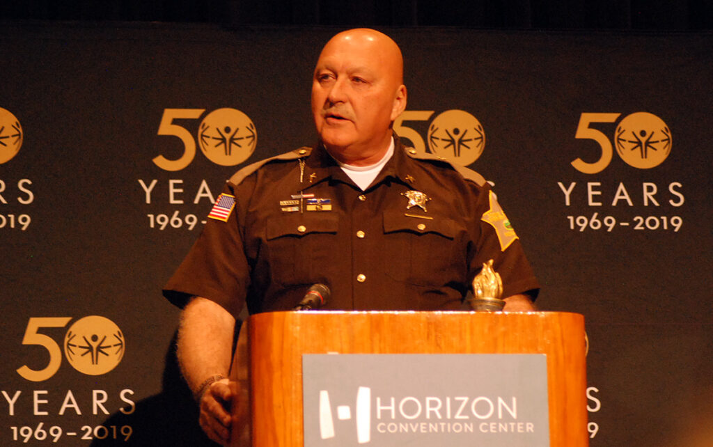 Boone County Sheriff Michael Nielsen accepts award as 2018 Spirit of Special Olympics Indiana LETR Officer of the Year.