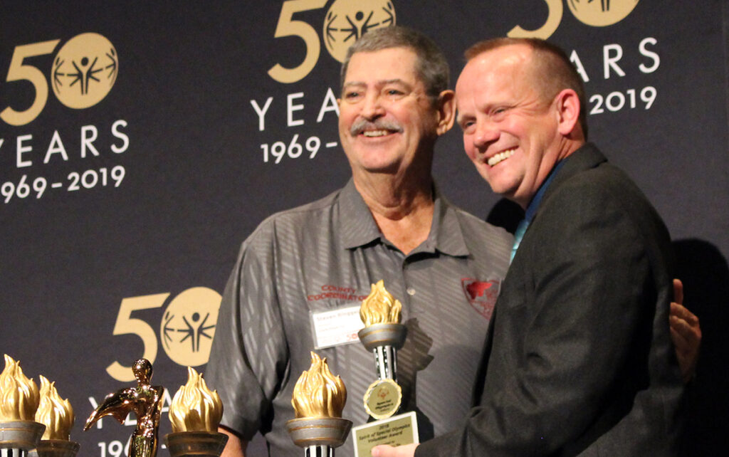 Steve Bingelli onstage accepting his award for Special Olympics Volunteer of the Year.