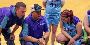 Tito Castillo taking a knee and coaching his Special Olympics team.