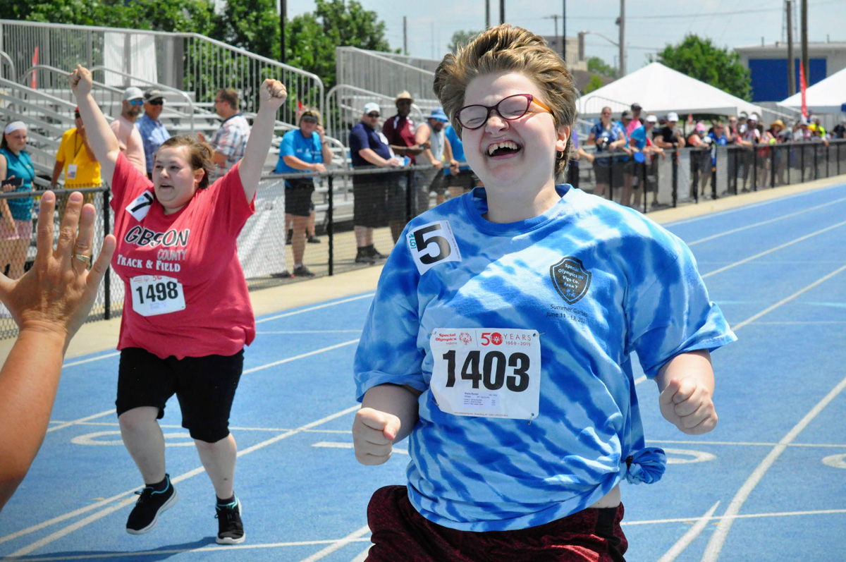 Athletes cheering as they cross the finish line