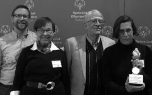 Four people holding Spirit of Special Olympics Family of the Year award