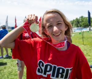 Athlete holding up competition medal