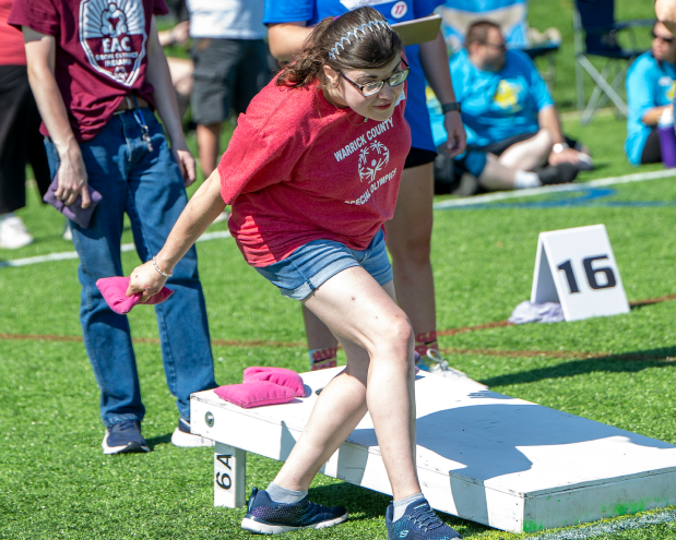 Girl playing cornhole