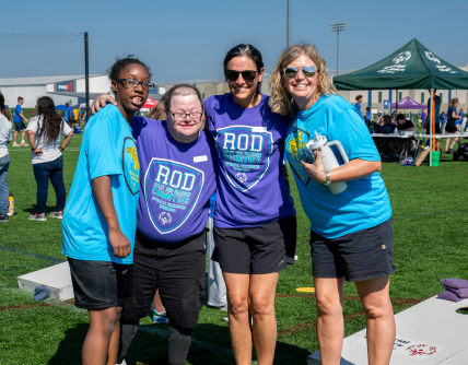 Group of four people smiling for photo