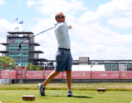 Man Swinging Golf Club