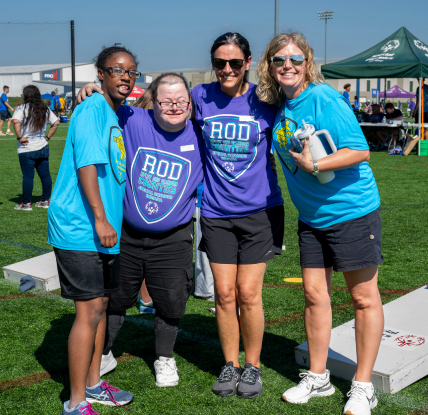 Athletes standing with volunteers