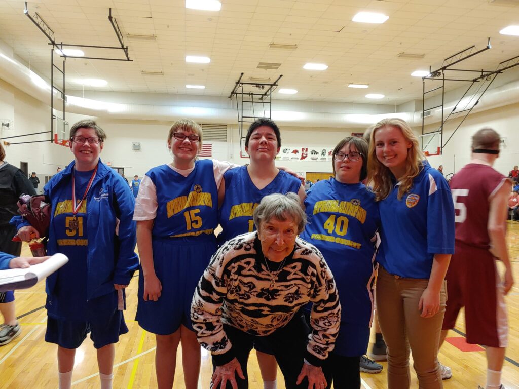 Coach Lorrie Woycik smiling with Special Olympics Indiana