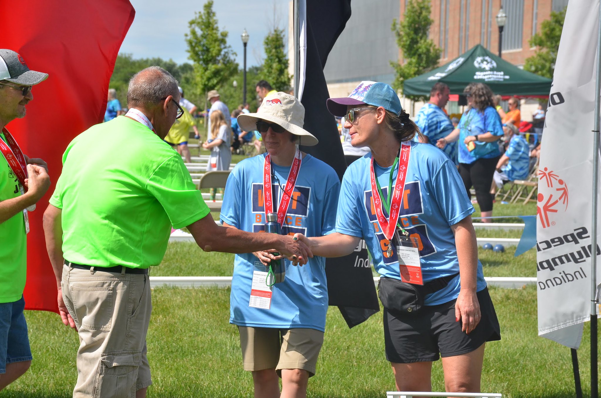 man in green shirt talking to participants