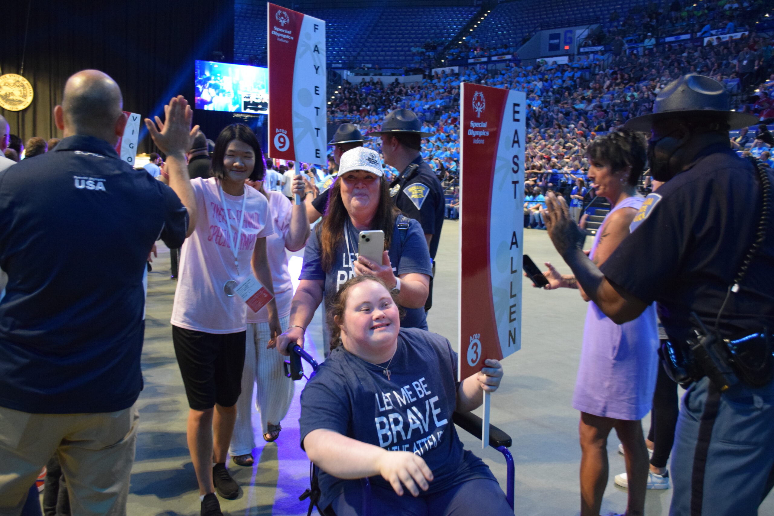 An athlete from East Allen County rolls through the high-five line in her wheelchair during the 2025 Opening Ceremony.